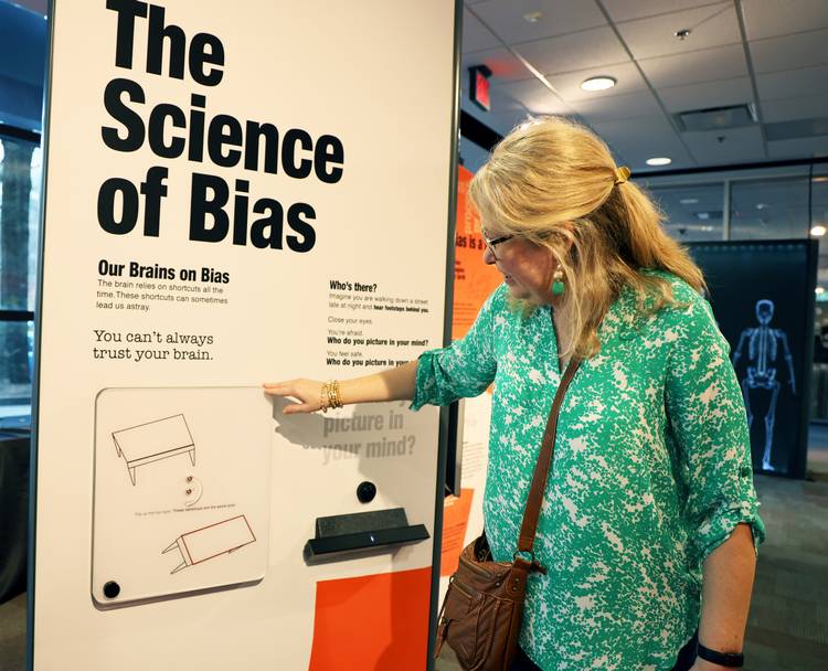 Interactive elements display how bias is reflected in product design, advertising, architecture and technology.